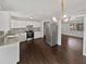 Open concept kitchen with stainless steel appliances and an elegant modern light fixture at 332 Hickory Acres Se Dr, Smyrna, GA 30082