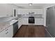 Modern kitchen with white cabinetry, stainless steel appliances, and granite countertops at 332 Hickory Acres Se Dr, Smyrna, GA 30082