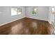 Open-concept living room with hardwood floors and large windows, bathed in natural light at 332 Hickory Acres Se Dr, Smyrna, GA 30082