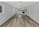 Open living room featuring sleek wood floors and a cozy brick fireplace at 332 Hickory Acres Se Dr, Smyrna, GA 30082