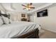 Luxurious main bedroom with white linens, ornate bed frame, and a view into the ensuite at 511 Winter View Way, Stockbridge, GA 30281