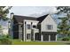 Charming two-story home features a stone facade, arched entry, and a two-car garage providing curb appeal at 140 Lake Estates Dr, Roswell, GA 30075