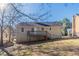 Exterior elevation of home with backyard, deck, and wooded perimeter at 5876 Old Wellborn Trce, Lithonia, GA 30058