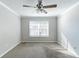 Neutral bedroom featuring a ceiling fan and a window bringing in plenty of natural light at 5876 Old Wellborn Trce, Lithonia, GA 30058