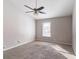 Bedroom with a ceiling fan, neutral carpet, and natural light streaming through the window at 5876 Old Wellborn Trce, Lithonia, GA 30058