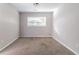 This bedroom offers natural light with carpet flooring at 5876 Old Wellborn Trce, Lithonia, GA 30058