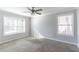 Bedroom with two windows providing natural light, neutral walls, and plush carpeting at 5876 Old Wellborn Trce, Lithonia, GA 30058