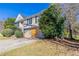 Landscaped front yard with lush greenery and a two-car garage on a sunny day at 5876 Old Wellborn Trce, Lithonia, GA 30058