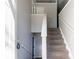Bright foyer featuring staircase with neutral carpet and white banister and railings at 5876 Old Wellborn Trce, Lithonia, GA 30058