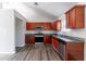 Kitchen with dark wood cabinets, stainless steel appliances, and granite countertops at 5876 Old Wellborn Trce, Lithonia, GA 30058