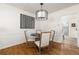 Bright dining area with hardwood floors, stylish light fixture, and wainscoting at 834 Heritage Sq, Decatur, GA 30033