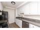Bright kitchen features granite countertops, stainless steel appliances, and white cabinets at 834 Heritage Sq, Decatur, GA 30033