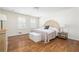 Light-filled main bedroom boasts hardwood floors and stylish decor at 834 Heritage Sq, Decatur, GA 30033