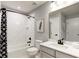 Full bathroom with a tub and shower combination with a white marble surround and stylish black fixtures at 1148 Burlington Ct, Mcdonough, GA 30253