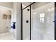 Modern bathroom features an elegant glass shower with a built-in seat and marble-look walls at 1148 Burlington Ct, Mcdonough, GA 30253