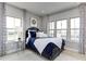 Comfortable bedroom with three large windows for natural light and custom curtains at 1148 Burlington Ct, Mcdonough, GA 30253