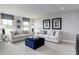 Bright living room with neutral furniture, an ottoman, and decor at 1148 Burlington Ct, Mcdonough, GA 30253