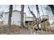 Backyard area with a wooden deck and stairs going down to the back of the property at 1198 Oak Knoll Ct, Lithonia, GA 30058