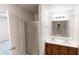 Bright bathroom featuring double sinks, a shower, and a large mirror at 1198 Oak Knoll Ct, Lithonia, GA 30058