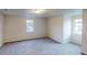 Bright bedroom with neutral paint, carpet, and natural light from two windows at 1198 Oak Knoll Ct, Lithonia, GA 30058