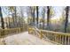 Large wooden deck with railings and stairs going to backyard area with natural views at 1198 Oak Knoll Ct, Lithonia, GA 30058