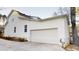 Exterior home elevation featuring a white garage door, siding, and driveway at 1198 Oak Knoll Ct, Lithonia, GA 30058