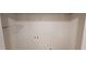 The laundry room has washer and dryer hook ups, wire rack shelving, and freshly painted walls at 1198 Oak Knoll Ct, Lithonia, GA 30058