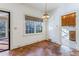 Sunlit dining room with wood floors, a chandelier and a door leading to a sunroom at 3587 Coldwater Canyon Ct, Tucker, GA 30084