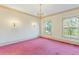 Bright living room with crown molding, decorative sconces, and large windows showcasing natural light at 3587 Coldwater Canyon Ct, Tucker, GA 30084