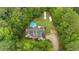 Aerial view of home surrounded by lush greenery, featuring a pool and long driveway at 4156 Holly Springs Rd, Rockmart, GA 30153