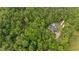 Aerial shot highlighting the house, the pool, and the lush tree coverage on the property at 4156 Holly Springs Rd, Rockmart, GA 30153