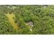 A tranquil property with a house, pool, long driveway surrounded by dense woodlands from above at 4156 Holly Springs Rd, Rockmart, GA 30153