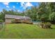 Expansive backyard features a wooden deck, above-ground pool, lush green grass, and mature trees, offering a private outdoor retreat at 4156 Holly Springs Rd, Rockmart, GA 30153