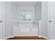 Bright bathroom featuring a white soaking tub with tile surround and natural light from a window at 4156 Holly Springs Rd, Rockmart, GA 30153