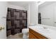 Bathroom with tile flooring, shower with decorative curtain and a single sink vanity at 4156 Holly Springs Rd, Rockmart, GA 30153