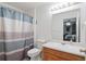 Bathroom with a shower/tub combo, updated vanity and mirror, plus blue and white striped shower curtain at 4156 Holly Springs Rd, Rockmart, GA 30153