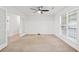 Bright bedroom with a ceiling fan, large window and french doors leading to another room at 4156 Holly Springs Rd, Rockmart, GA 30153