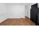 Bedroom with hardwood floors, white walls, and an entertainment center at 4156 Holly Springs Rd, Rockmart, GA 30153