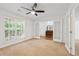 Cozy bedroom featuring a ceiling fan, a large window and french doors leading to a study at 4156 Holly Springs Rd, Rockmart, GA 30153