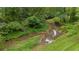 Scenic creek surrounded by lush greenery and mature trees, adding a natural and tranquil element to the property at 4156 Holly Springs Rd, Rockmart, GA 30153