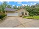 Well-maintained single-story home with an attached garage and spacious driveway, surrounded by mature trees at 4156 Holly Springs Rd, Rockmart, GA 30153