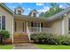 Welcoming front porch with white railings and steps, perfect for enjoying the peaceful neighborhood at 4156 Holly Springs Rd, Rockmart, GA 30153