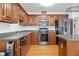 Well-equipped kitchen with wooden cabinets and stainless steel appliances, ideal for preparing delicious meals at 4156 Holly Springs Rd, Rockmart, GA 30153