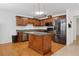 Traditional kitchen features an island, wood cabinetry, and stainless steel appliances at 4156 Holly Springs Rd, Rockmart, GA 30153