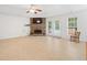 Spacious living room featuring a stone fireplace and French doors, offering a comfortable and stylish gathering space at 4156 Holly Springs Rd, Rockmart, GA 30153