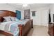 The main bedroom features a large bed with stylish bedding, a ceiling fan and bright neutral walls at 4156 Holly Springs Rd, Rockmart, GA 30153