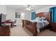 Spacious main bedroom features a ceiling fan, ensuite bathroom, and a large bed with stylish bedding at 4156 Holly Springs Rd, Rockmart, GA 30153