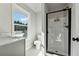 Beautiful bathroom featuring a glass shower and a grey vanity with a large window above the toilet at 6035 Hendrix Rd, Cumming, GA 30040