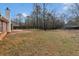 Expansive backyard with a privacy fence, mature trees, and space for outdoor activities at 10 Mcgiboney Pl, Covington, GA 30016