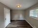 This bedroom features modern dark wood flooring, neutral walls, and a large window to let in plenty of natural light at 3900 Boulder Park Sw Dr, Atlanta, GA 30331